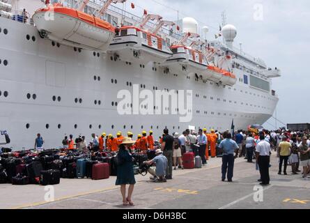 I passeggeri sono accanto a loro valigie dopo l'arrivo di Costa Allegra in nave da crociera della Victoria Harbour, Seychelles Island, 01 marzo 2012. I disabili la nave di crociera è arrivata in porto nell'isola nazione delle Seychelles dopo tre giorni in mare senza alimentazione. Phtoto: CAROLA FRENTZEN Foto Stock