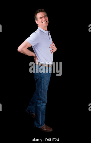 La mezza età uomo che soffre di dolori alla schiena Sfondo nero Foto Stock