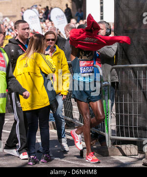 Londra, East Smithfield, 21 aprile 2013. Mo Farah, somale nato e Team GB di Olimpiadi doppia medaglia nel 5,000m e 000m a Londra 2012, indossa il suo sponsor felpa dopo aver terminato la sua corsa, appena prima di miglio 13. Prima della gara Farah aveva detto che egli ha voluto restare con la Elite Uomini Maratona fino a metà strada e ha fatto proprio questo. Foto Stock