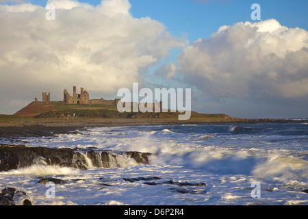 Surf sulle rocce, Dunstanburgh Castle, Northumberland, England, Regno Unito, Europa Foto Stock