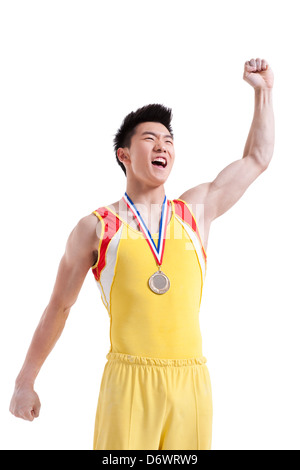 Atleta con una medaglia fustellatura dell'aria per vincere Foto Stock