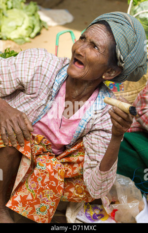 Vecchia donna con oltraggiosa sigaro in Nyaung oo Mercato in Bagan, Myanmar 2 Foto Stock