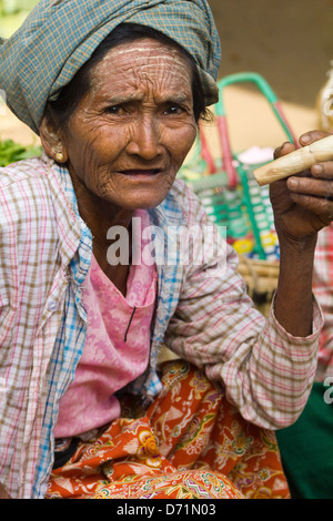 Vecchia donna con oltraggiosa sigaro in Nyaung oo Mercato in Bagan, Myanmar Foto Stock
