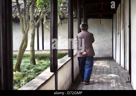 Vecchia donna passeggiando nella umile Administrator's Garden, Suzhou Foto Stock