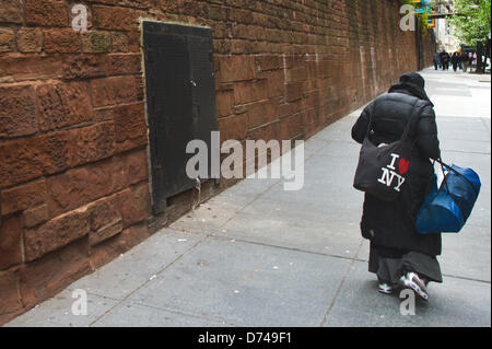 Una persona senza dimora passeggiate lungo una strada con un "Io amo New York' borsa di New York, Stati Uniti d'America, 20 aprile 2013. Foto: Arno Burgi Foto Stock