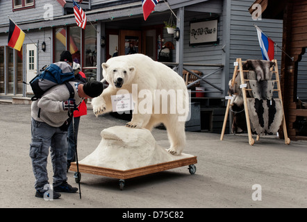 Per turisti in cerca di "Si prega di non toccare " segno su un ripieno a base di orso polare nel quartiere dello shopping di Longyearbyen, Svalbard Foto Stock