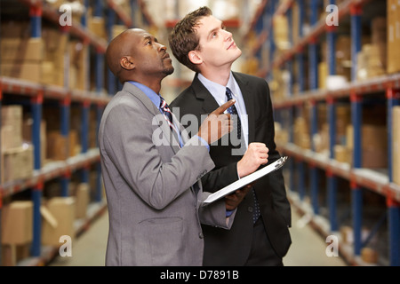 Due imprenditori aventi la discussione in magazzino Foto Stock