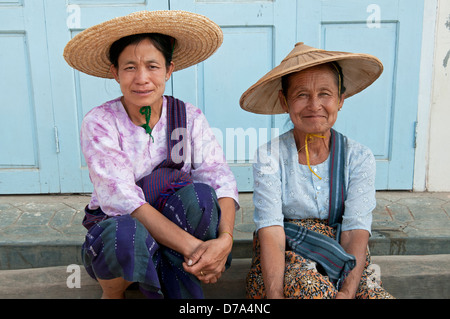 Due donne giovani e vecchi sedersi su un passo nel villaggio Nyuangshwe Lago Inle Myanmar (Birmania) Foto Stock