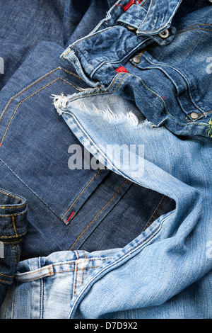 Varie paia di jeans pantaloni sparsi nel caos. Foto Stock