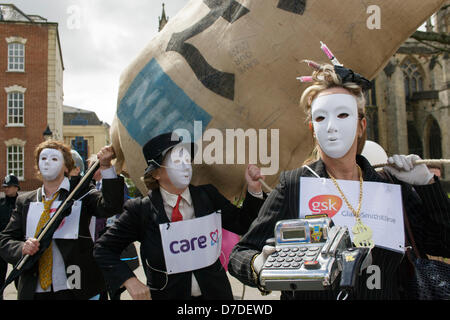 Bristol,UK,4 Maggio,2013. I manifestanti che indossa una maschera facciale bianca e portante una cassa di protesta contro la privatizzazione del NHS. Credito: lynchpics / Alamy Live News Foto Stock