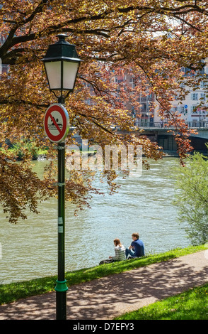 Giovane rilassante sul Ill riverside Strasburgo Alsace Francia Foto Stock
