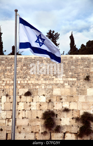 Bandiera di Israele che fluttua nel vento davanti al santo il Muro del Pianto, uno dei luoghi più sacri per il popolo ebraico. Foto Stock