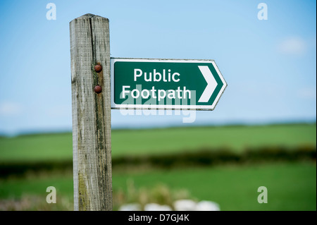 Un verde sentiero pubblico segno nel mondo rurale, Devon contro un cielo blu Foto Stock