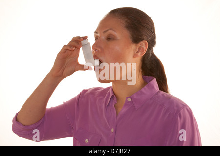 Donna che mantiene inalatore. Foto Stock