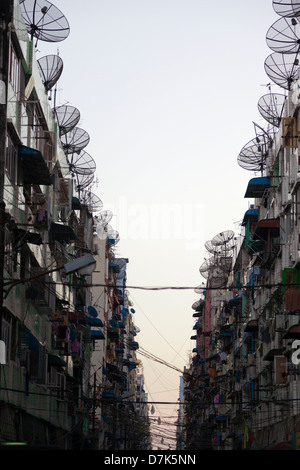 Gaunt street foderato con antenne paraboliche nel centro di Yangon, Myanmar 6 Foto Stock