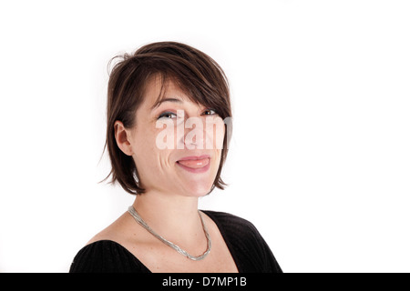 Variazione espressione sul viso di una giovane donna bruna in studio Foto Stock