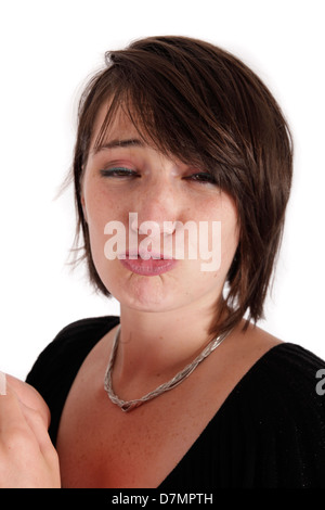 Variazione espressione sul viso di una giovane donna bruna in studio Foto Stock