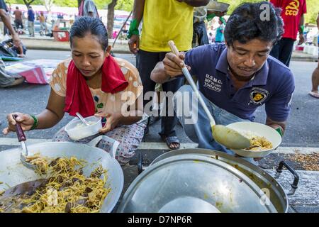 Bangkok, Tailandia. Maggio 11, 2013. I manifestanti in fila per la colazione durante gli agricoltori' protesta. Diverse centinaia di piccola famiglia di scala gli agricoltori si sono accampate a ''Government House'' (l'ufficio del Primo Ministro a Bangkok alla pressione Primo Ministro tailandese Shinawatra Yingluck per offrire su di lei promette di migliorare la situazione della famiglia di agricoltori. Per il popolo€™s movimento per una società giusta (P-move) è un'organizzazione di rete il cui obiettivo è rafforzare la voce dei diversi ma cause relative al lavoro per portare la giustizia per gruppi emarginati in Thailandia, compresi i diritti alla terra per i piccoli agricoltori, Foto Stock