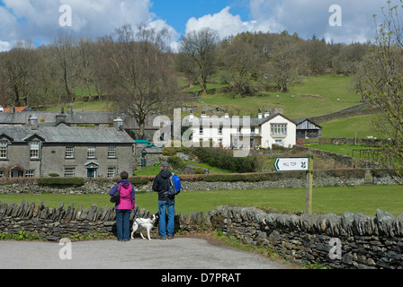 Giovane con il cane nel villaggio di Near Sawrey, Parco Nazionale del Distretto dei Laghi, Cumbria, England Regno Unito Foto Stock