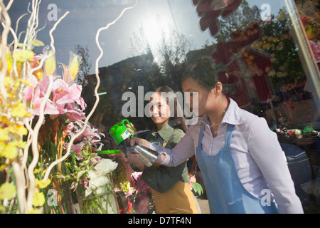 Fioraio lavorando in negozio di fiori Foto Stock