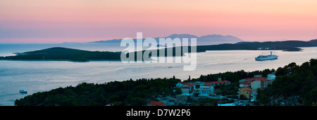 Isole Pakleni e isola di Vis, una nave da crociera ormeggiata al tramonto, visto dall'isola di Hvar, costa dalmata, Mare Adriatico, Croazia Foto Stock
