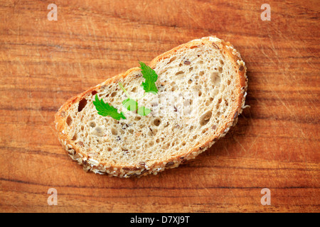 Fetta di grano intero pane su un tagliere Foto Stock