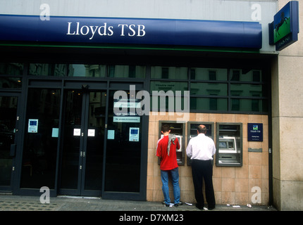 I clienti che utilizzano la Lloyds TSB bancomat a macchina, charing cross di Londra, Regno Unito. Foto Stock