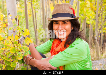 Ispanico donna seduta nella foresta Foto Stock