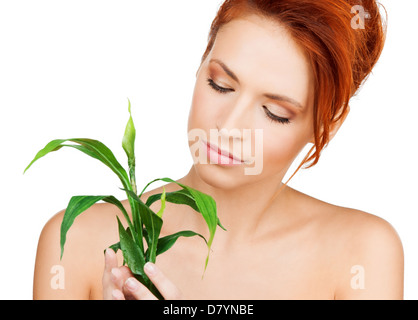 Donna con germoglio verde Foto Stock