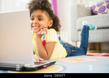 African American Girl utilizzando laptop sul pavimento Foto Stock