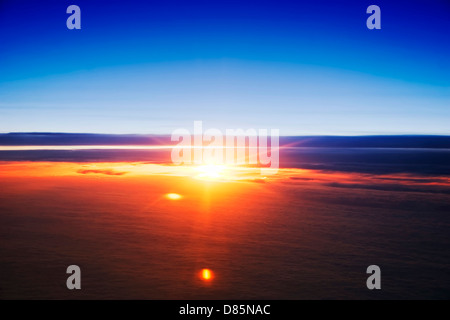 Vista spettacolare di un tramonto sopra le nuvole dall'aeroplano Foto Stock