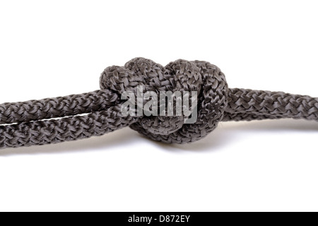 Corda nero nodo su sfondo bianco Foto Stock