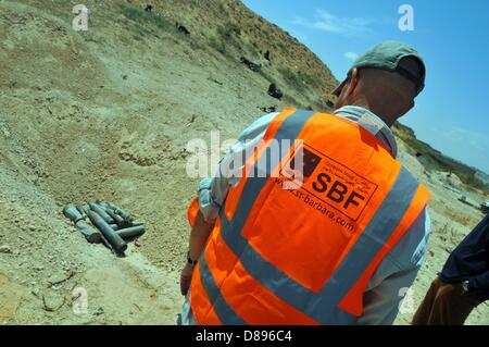 Un dipendente delegata del tedesco di Santa Barbara Foundation esamina un mucchio di raccolte di munizioni, che sta per essere distrutto in un esplosione controllata, su un terreno di esplosione nei pressi di Tripolis, Libia, 6 maggio 2013. Fin dalla sua fondazione nel 1995, la Santa Barbara Foundation supporta il gioco da armi da fuoco ed esplosivi resti di ex aree di conflitto e teatri di guerra e fornisce aiuti umanitari. La ONG è attivo in Libia dall inizio del 2012 e finanziato tra gli altri per mezzo del German Federal Foreign Office. Foto: Matthias Tödt Foto Stock