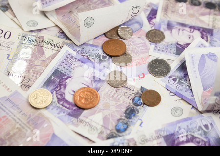 Venti pound banconote e monete su un tavolo. Foto Stock