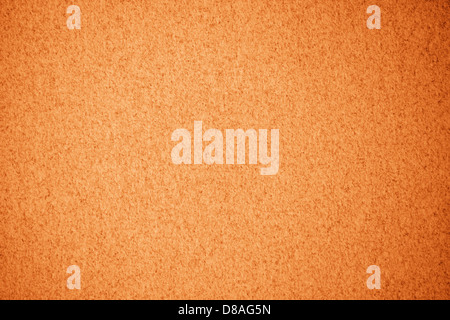 Carta a trama con motivo a macchie arancioni, ideale per progetti creativi o di design. La superficie è ruvida con intensità di colore variabile, conferendole un aspetto naturale e organico. Foto Stock
