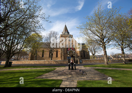 Città di Dornoch, Scozia. Il pubblico di bere bene con la facciata sud di Dornoch Cathedral in background. Foto Stock