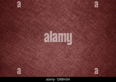 Vista ravvicinata del tessuto marrone che mostra i suoi colori e la sua consistenza. La tonalità rossa profonda del tessuto è evidenziata dal motivo intrecciato, che lo rende ideale per applicazioni di moda e interior design. Foto Stock