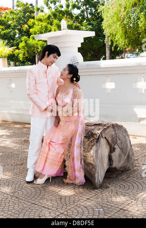 Asian Thai groom sta cercando la sua sposa in volto sorridente. Foto Stock