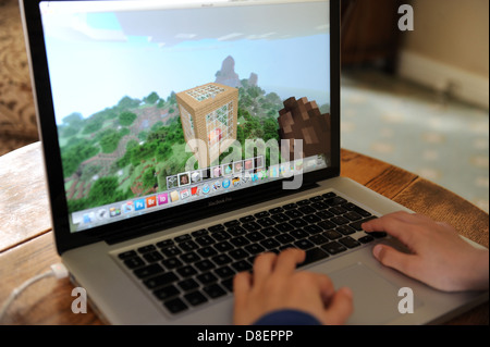 Un 8 anno vecchio ragazzo giocando minecraft sul suo computer Apple IPAD nella sua camera da letto a casa. Foto Stock