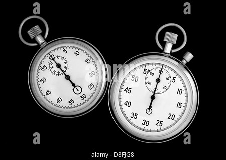 Due cronometro su nero Foto Stock