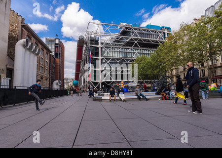 Parigi, Francia. Padre e figlio giocare a calcio vicino al centro Pompidou e la Fontana Stravinsky Foto Stock