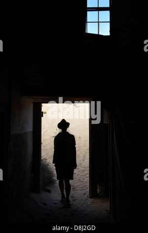 Persona in corridoio in casa abbandonata, Kolmanskop città fantasma, vicino a Luderitz, Namibia, Africa Foto Stock