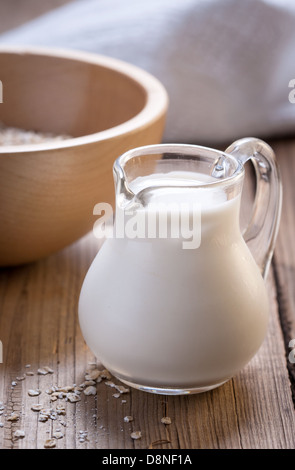 Una piccola brocca del latte su sfondo di legno Foto Stock