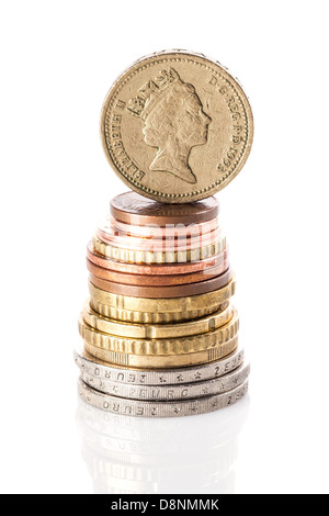 British pound coin sulla pila di euro e centesimi di euro su bianco superficie riflettente Foto Stock