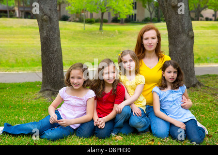 Insegnante di madre in figlia gli allievi nel parco giochi ritratto di gruppo sul prato Foto Stock