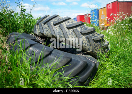 Vecchi pneumatici autocarro oggetto di dumping in un campo. Foto Stock