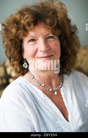 Ritratto di un sorridente donna di mezza età con il rosso dei capelli ricci. Foto Stock
