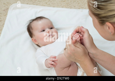 Madre tenendo la figlia della piedi Foto Stock