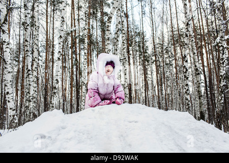 Una giovane ragazza che gioca nella neve Foto Stock