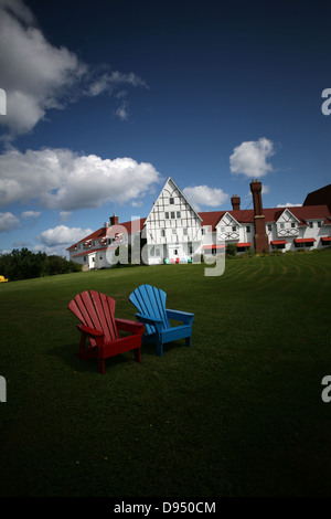 Colorate sedie Adirondack davanti la Keltic Lodge and Spa ingresso principale situato appena al di fuori della Cabot Trail in Ingonish, Nova Foto Stock